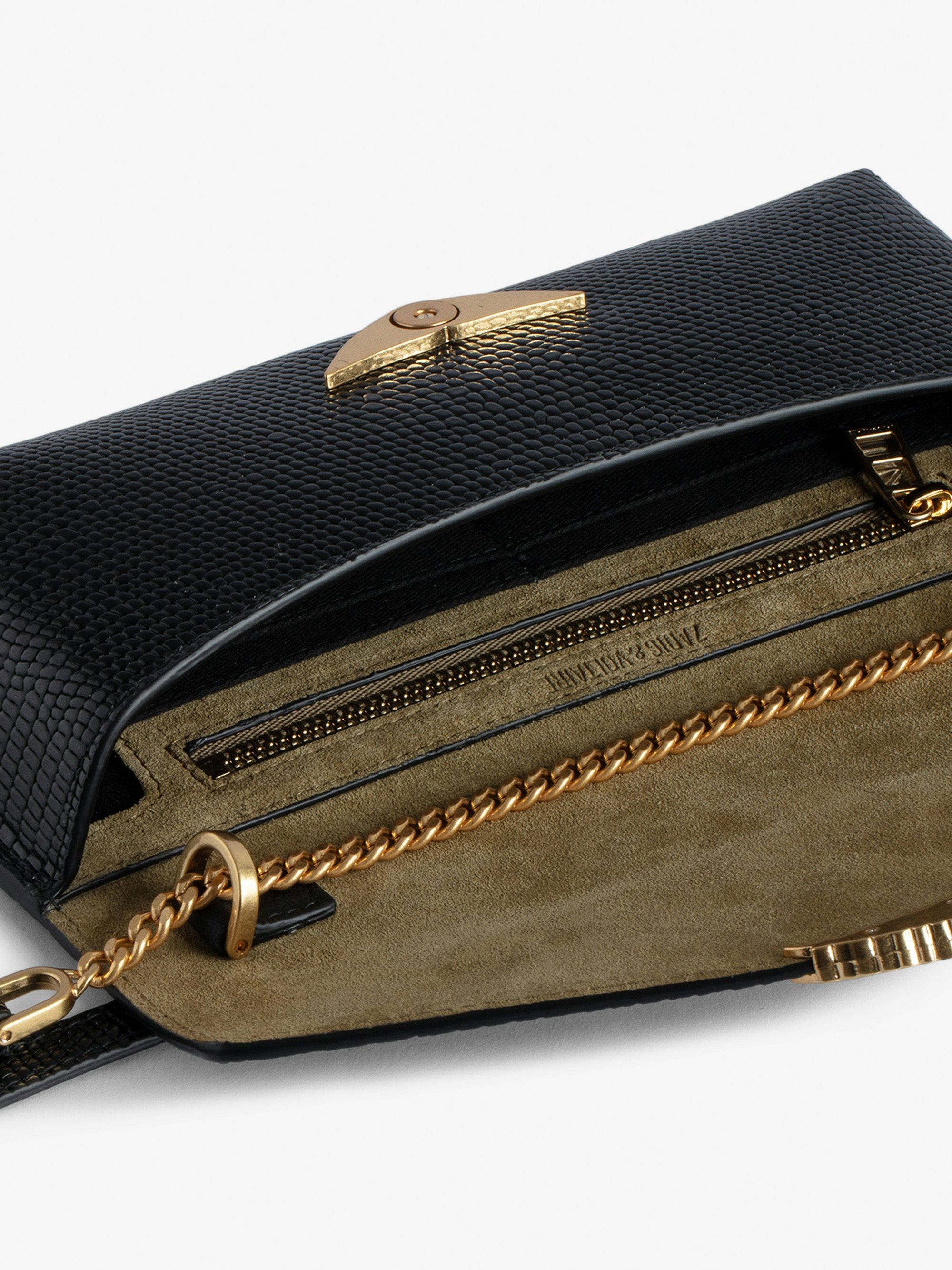 Borderline Embossed Clutch - Women’s black iguana-embossed leather clutch with shoulder strap with wings charm.